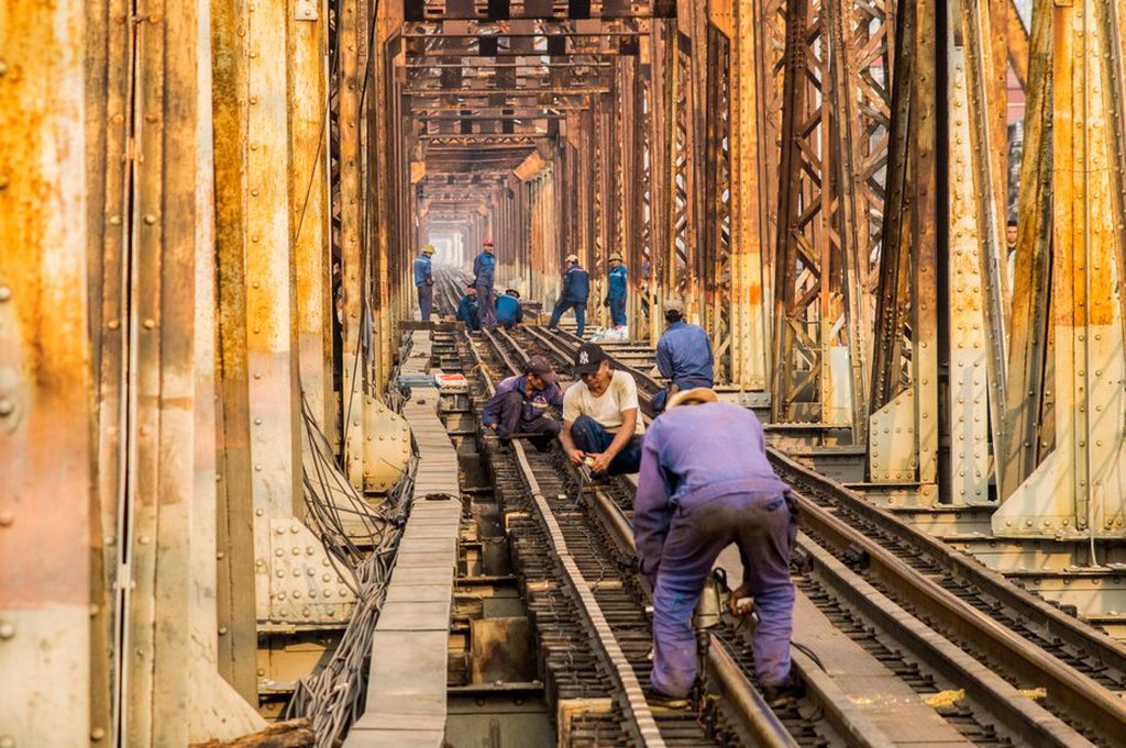 Engineers performing maintenance on a bridge structure