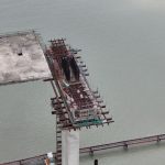 Workers performing maintenance on a bridge structure