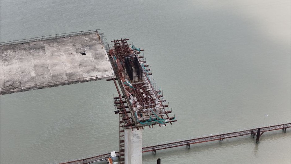 Workers performing maintenance on a bridge structure
