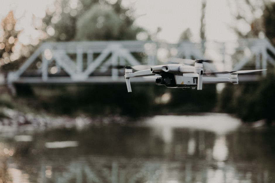 Drone conducting an aerial inspection of a bridge