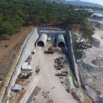 Workers reinforcing a tunnel in a seismic region
