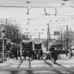 Level tram platform beside a marked pedestrian crossing
