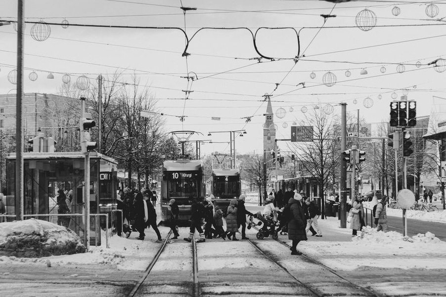 Level tram platform beside a marked pedestrian crossing