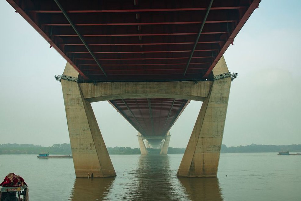 Engineer checks a bridge bearing beneath the deck