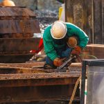 Inspector examines a steel bridge connection