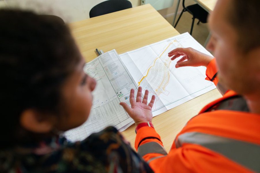 Engineers comparing site evidence with a project risk register
