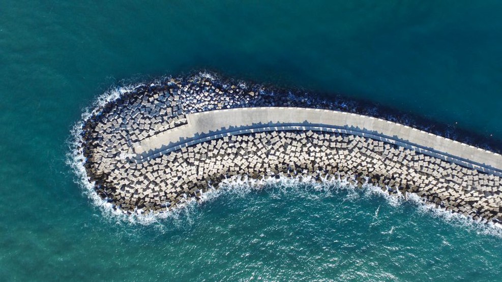 Rock armour protects a road embankment from waves