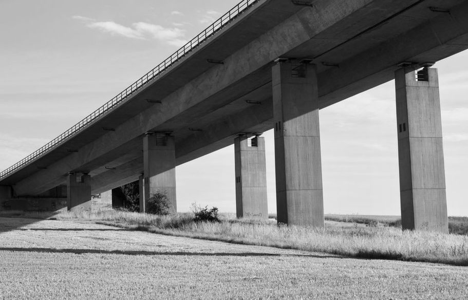Inspector examining the underside of an elevated roadway