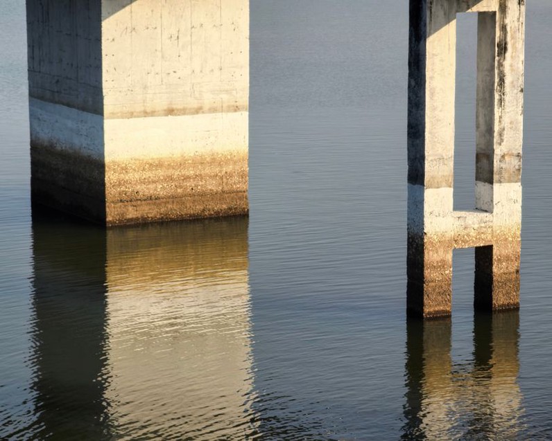 Inspector examining cracking on a bridge pier