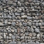 Drained highway cut with protective slope treatment