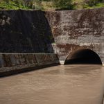 Roadside channel directing runoff toward a culvert