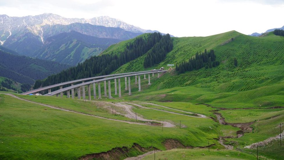 Road and rail infrastructure share a narrow mountain valley