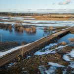 Rail embankment crossing low-lying wetland terrain