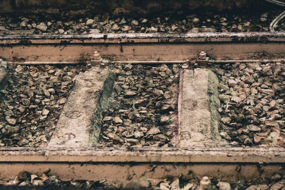 Ballast layers exposed beneath a railway track