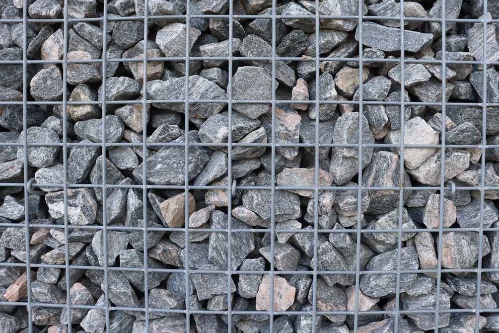 Geogrid layers extending behind a reinforced soil wall