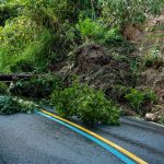 Debris reaches the ditch beside a road cutting