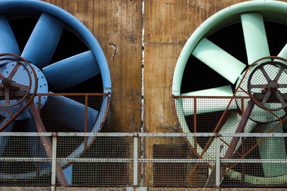 Jet fans installed along a road tunnel ceiling