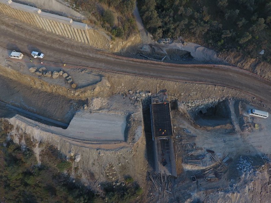Survey team measuring deformation beside a railway embankment