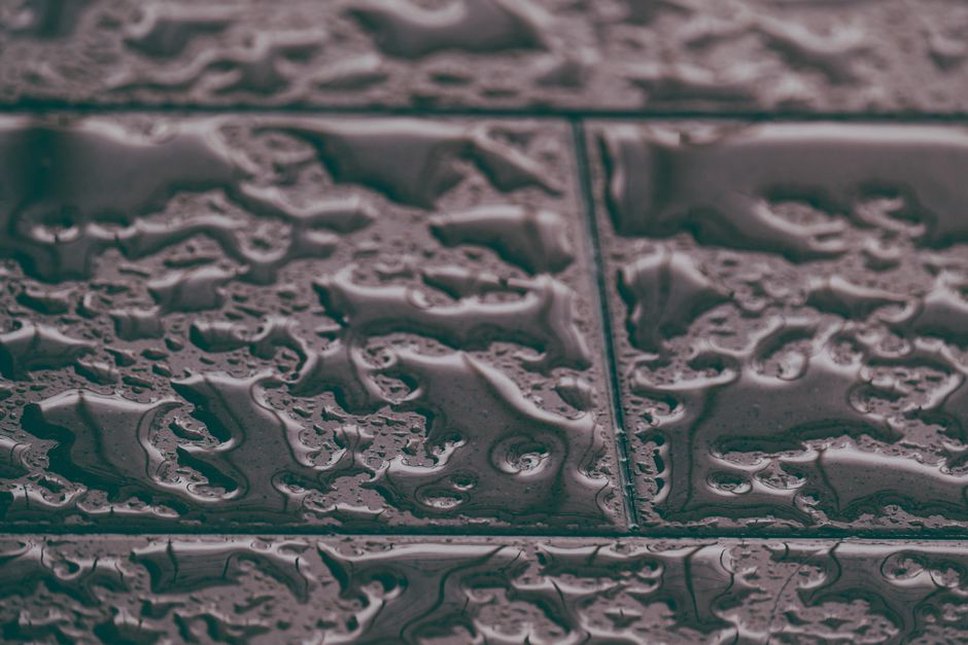 Water gathers between raised areas of road texture