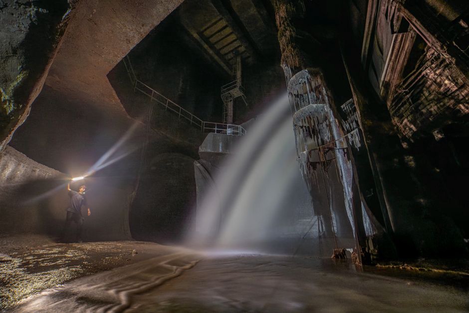 Engineer examining cracks on a concrete tunnel lining