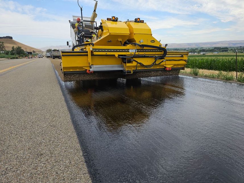 Roller compacting a freshly placed asphalt layer