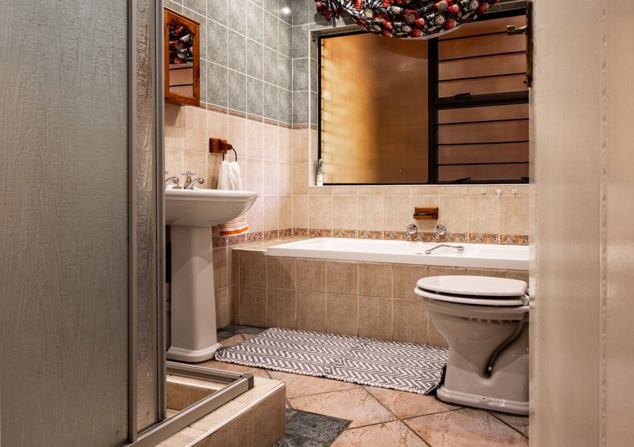 Flat bath mat beside a dry shower floor