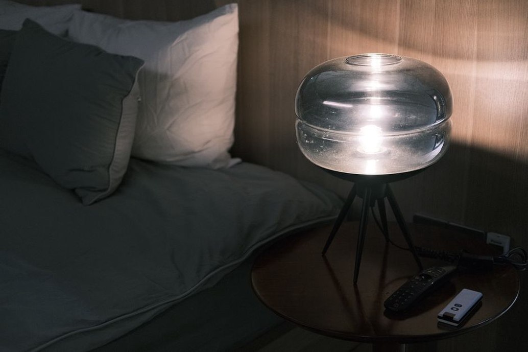 Bedside light illuminates a book without lighting the whole room