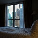 Closed curtains reduce light near the bed