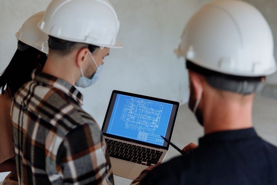 Engineer compares a bridge component with its drawing