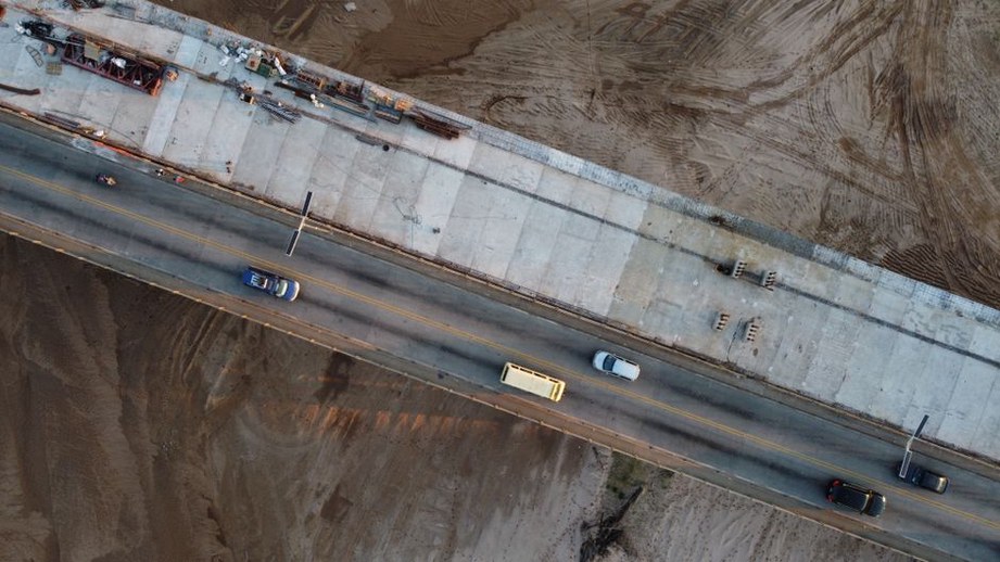 Engineer examining damaged concrete on a bridge deck