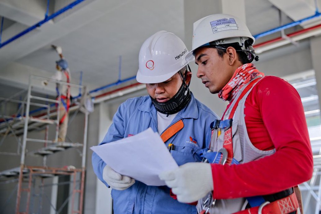 Engineer compares inspection notes with an online reference