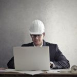 Engineer checks inspection findings beside field notes