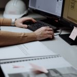 Engineer checks monitoring records against an inspection report
