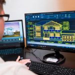 Engineers working with shared plans in an office