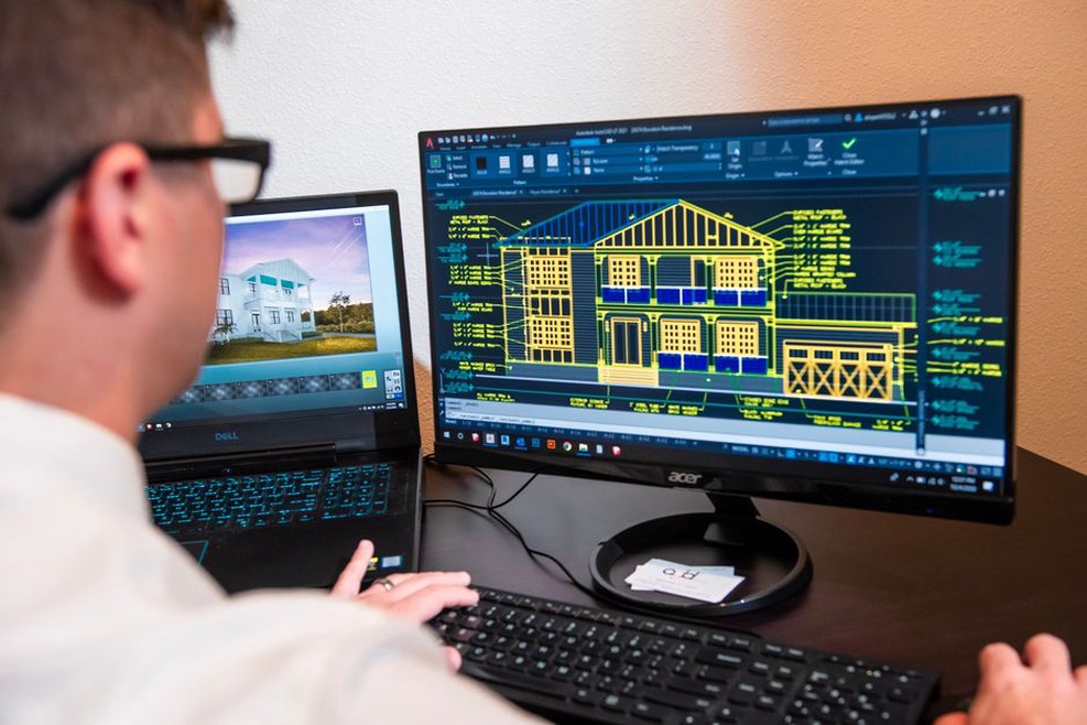 Engineers working with shared plans in an office