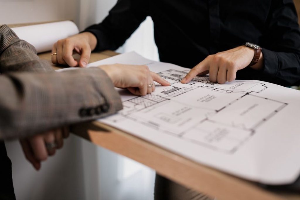Engineers examining bridge drawings together