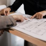 Engineers examining bridge drawings together