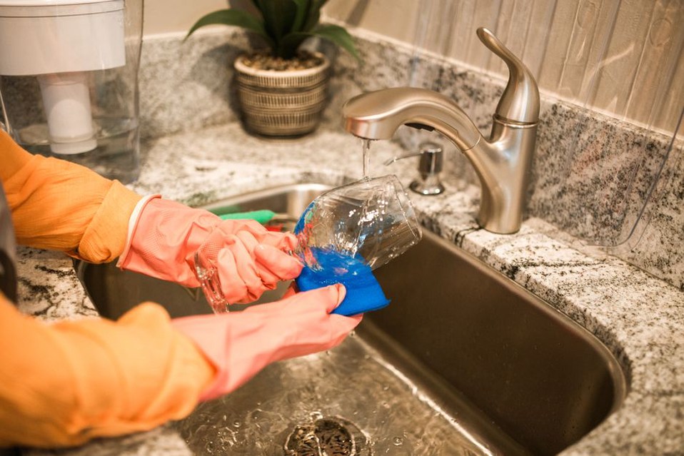 Removable dishwasher filter being cleaned