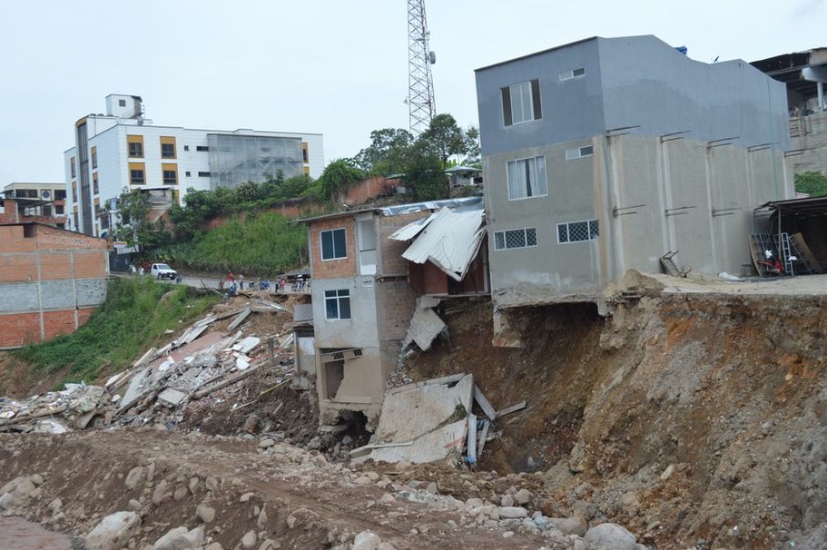 Engineers examine a settled bridge approach
