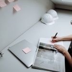 Engineer compares a report with handwritten questions