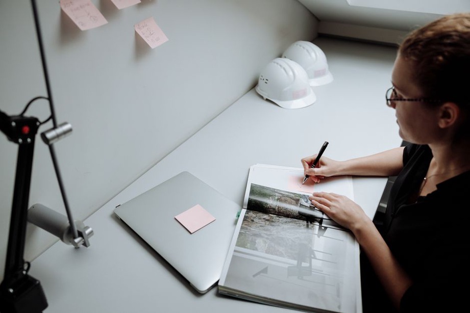Engineer compares a report with handwritten questions