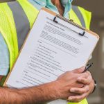 Engineer checking bridge inspection notes on a tablet