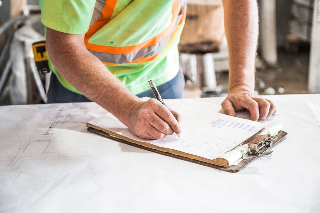 Engineer compares inspection records with bridge drawings