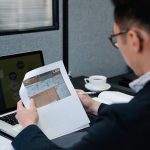 Engineer checks written feedback beside project documents