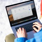 Engineer examines newsletter results on a laptop