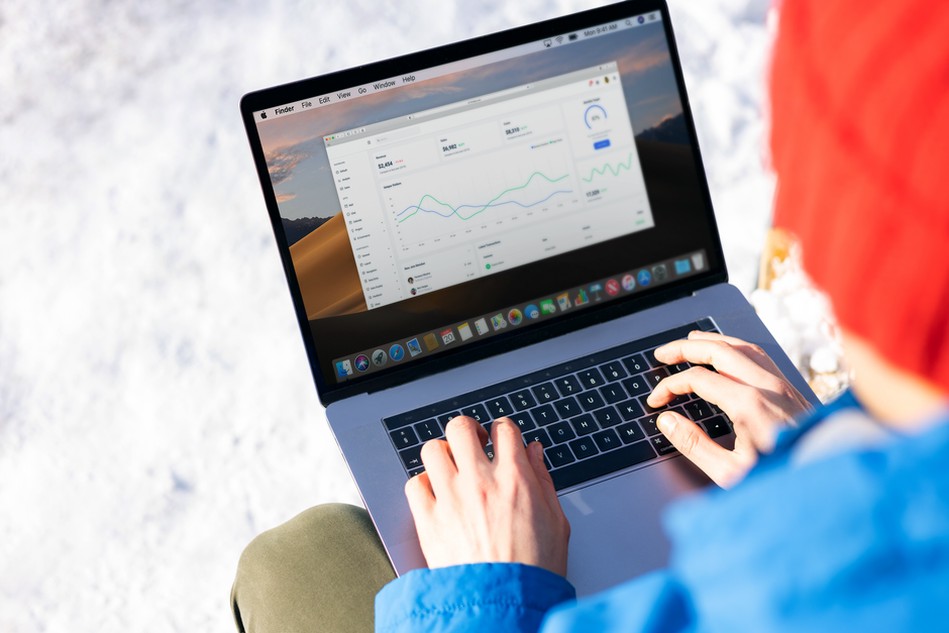 Engineer examines newsletter results on a laptop