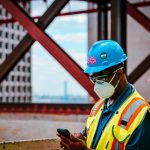 Engineer checks site information on a phone