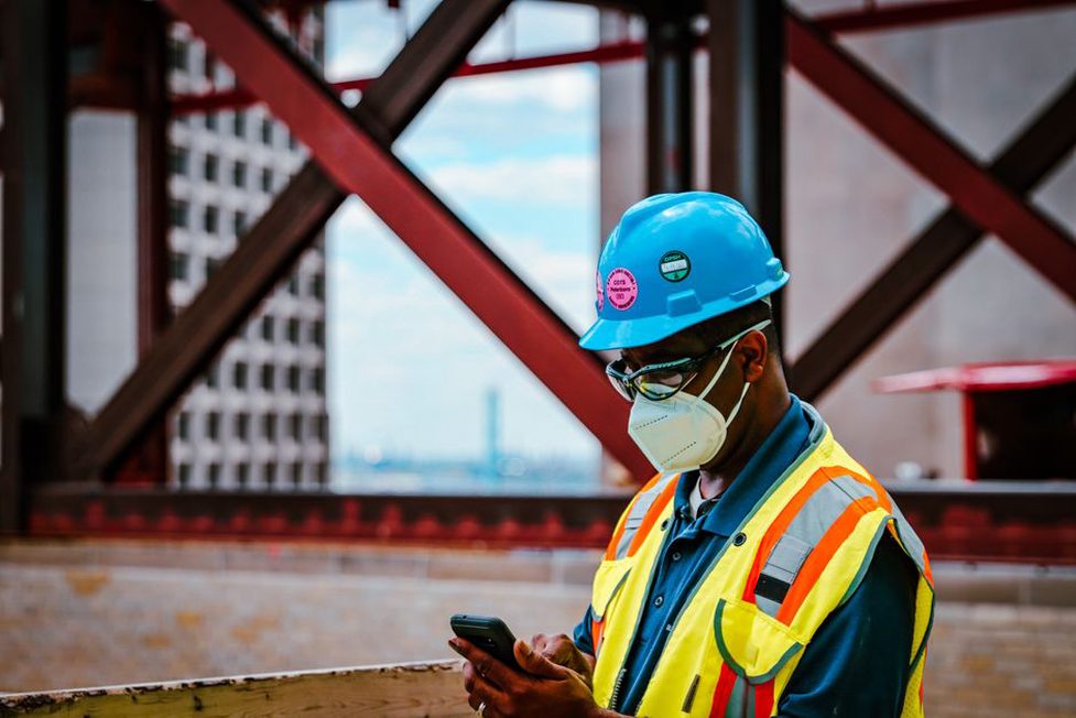 Engineer checks site information on a phone
