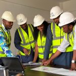 Colleagues compare an article draft with engineering drawings