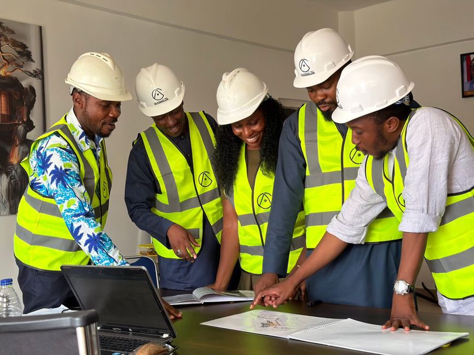 Colleagues compare an article draft with engineering drawings